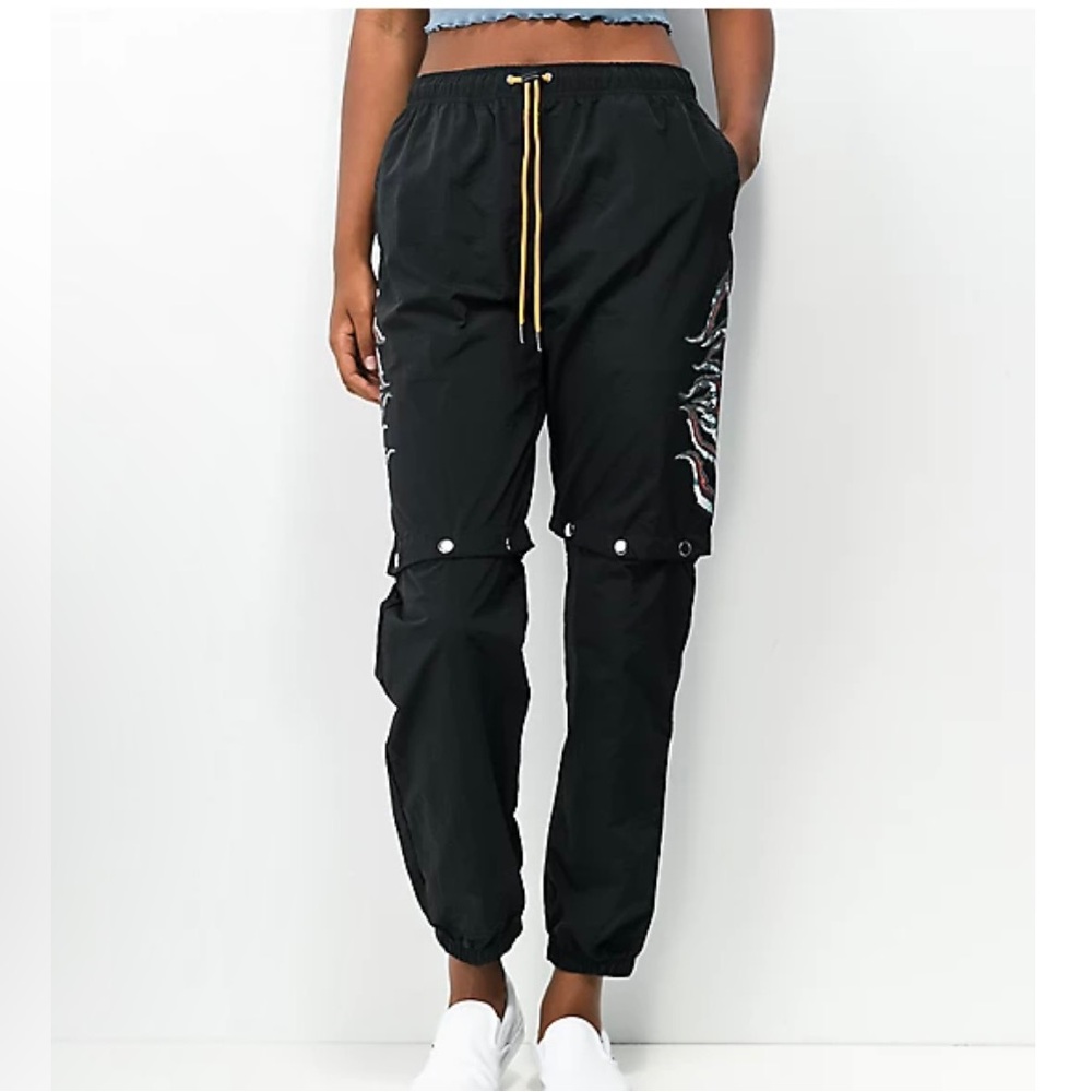 SWIXXZ Rustic Metal Black Track Pants transition to shorts with logo note hips